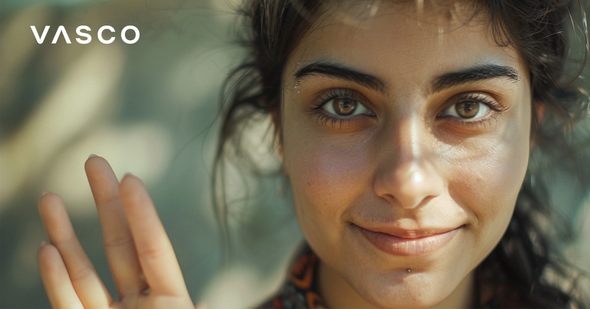 A woman with expressive eyes waving, highlighting how to say hello in various languages.