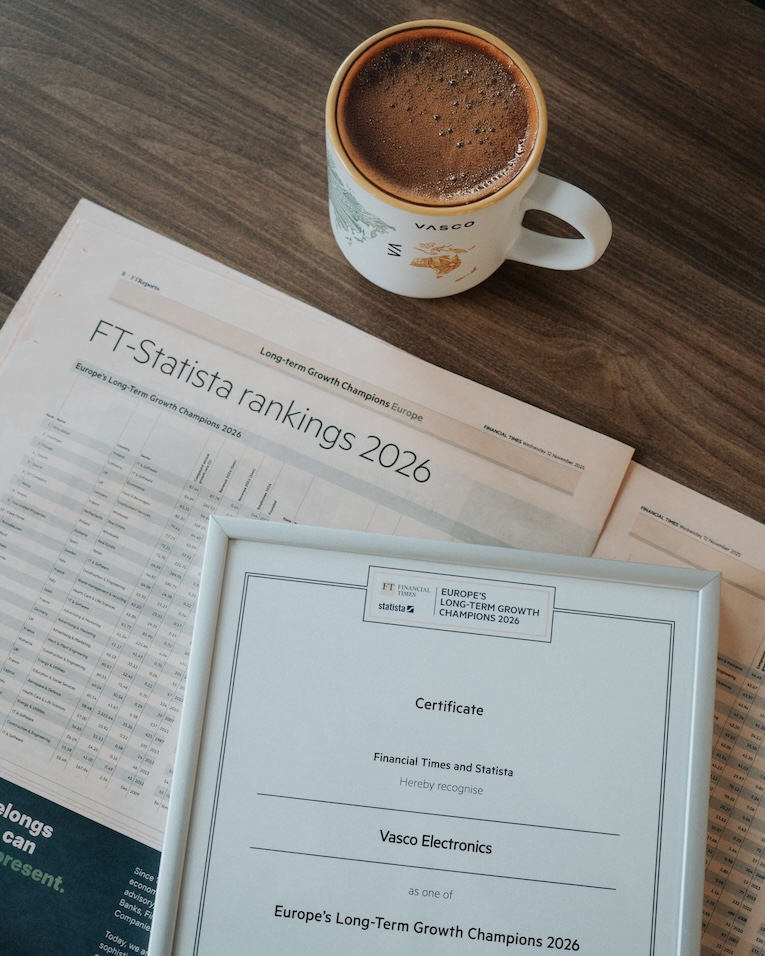 FT – Statista 2026 Na drewnianym stole leżą dyplom oraz gazeta z wyróżnieniem dla Vasco Electronics za znalezienie się w zestawieniu „Europe’s Long-Term Growth Champions 2026