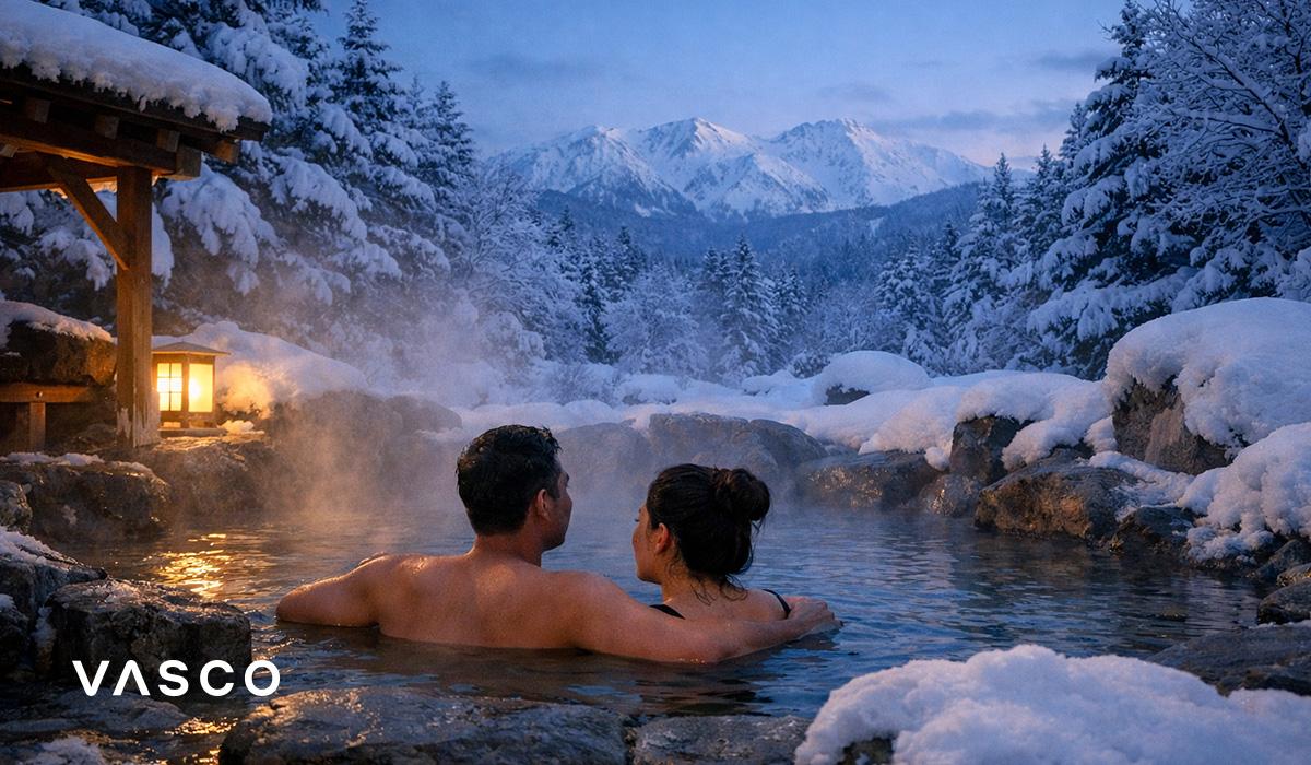 Couple relaxing in traditional Japanese onsen surrounded by snowy mountains – winter travel in Japan